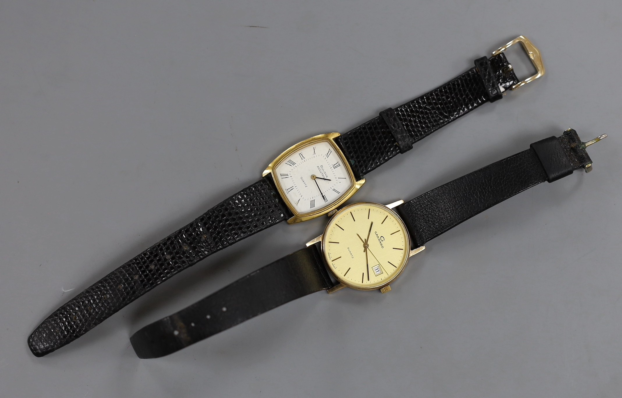 A gentleman's modern gold plated? Garrard quartz wrist watch and a similar steel and gold plated Bulova Accutron quartz wrist watch.